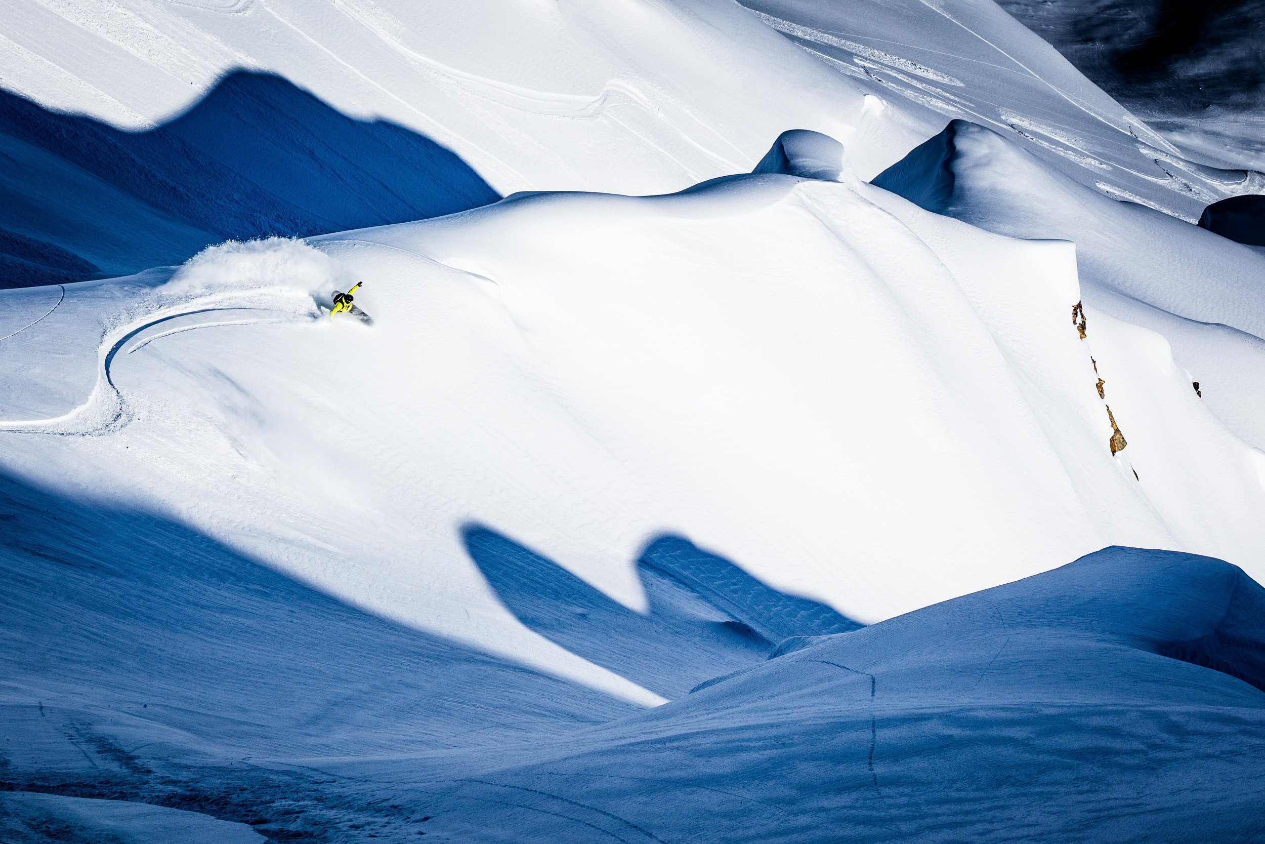 Snowboarding on a ridge in Alaska.