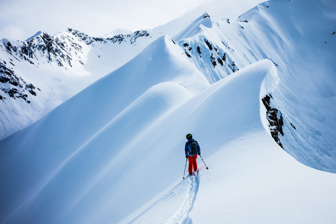 A skier scouts his next run.