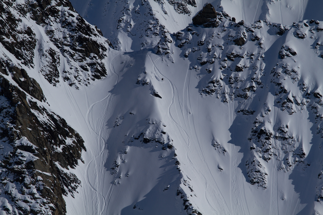 Skiers riding two chutes in Alaska.