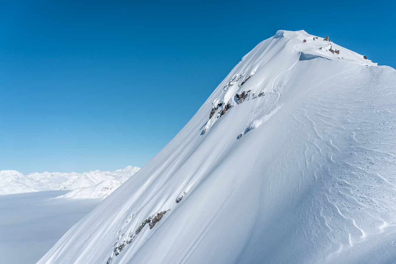 Snowboarding a huge peak in the Alaskan backcountry with Chugach Powder Guides